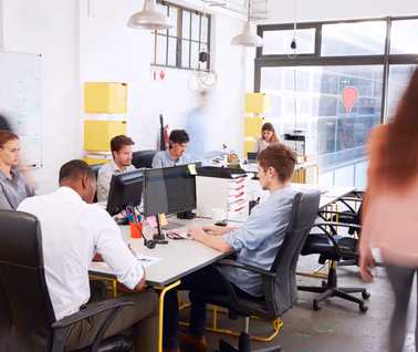 Tech office space with workers around table